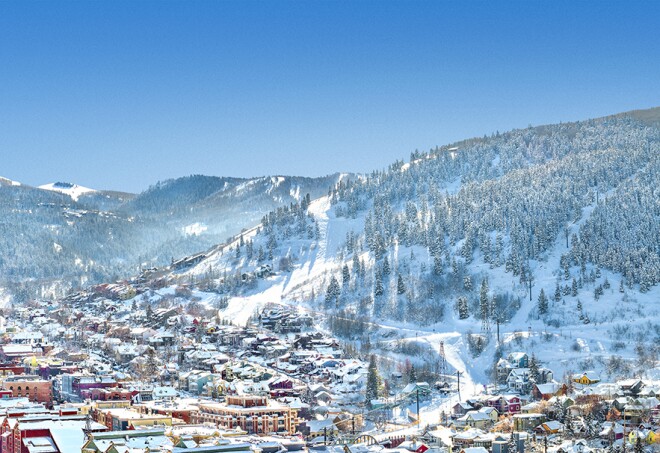 A panoramic view of the snowy mountains surrounding the valley of Park City, Utah.